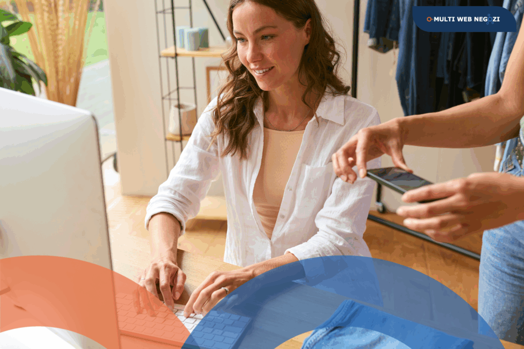 Commerciante al computer che lavora alla comunicazione del proprio negozio, simbolo del passaggio dal commercio tradizionale a quello moderno digitale.